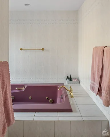 a living room with furniture and a baby crib