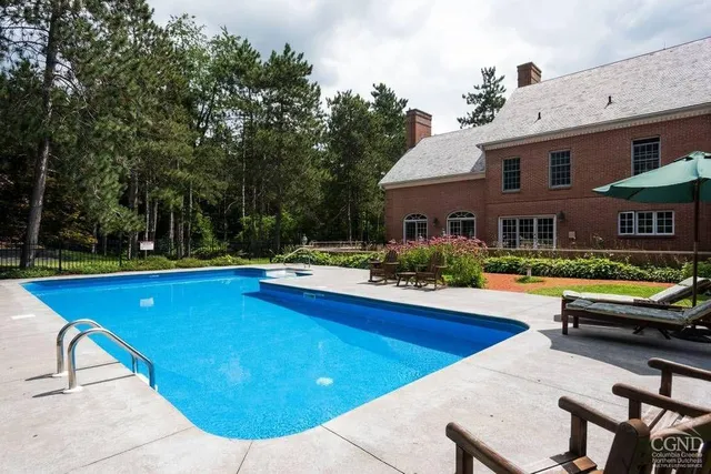 a view of swimming pool with chairs and tables