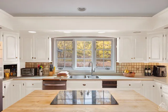 a kitchen with stainless steel appliances granite countertop a stove sink and cabinets
