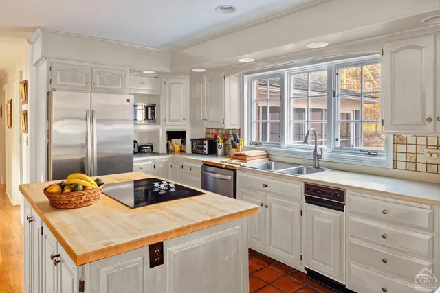 a kitchen with a sink stove and refrigerator