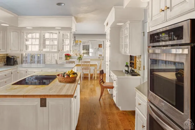 a kitchen with stainless steel appliances granite countertop a refrigerator a stove and a sink with cabinets