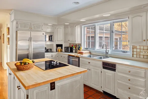 a kitchen with a sink stove and refrigerator