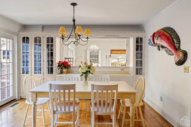 a view of a dining room with furniture and chandelier