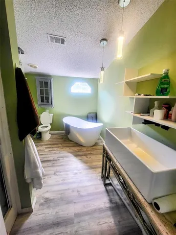 a spacious bedroom with a bed and a mirror