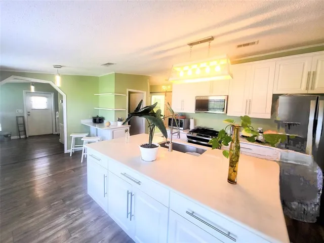 a view of a room with wooden floor and chair