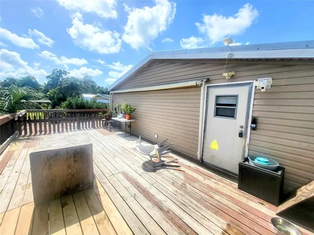 a view of a house with wooden deck
