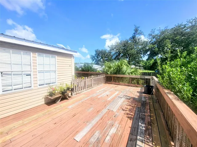 a view of a balcony with wooden floor