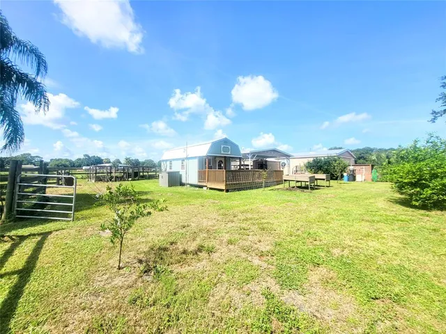 a backyard of a house with table and chairs