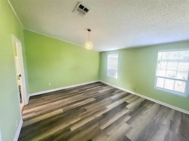a view of empty room with window and ceiling fan