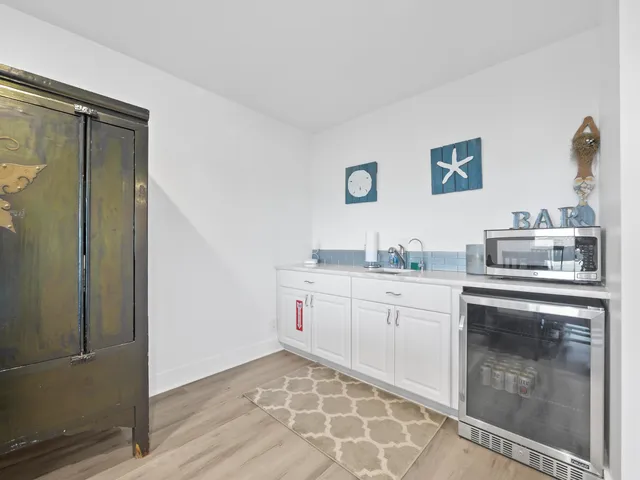 a living room with furniture and kitchen view