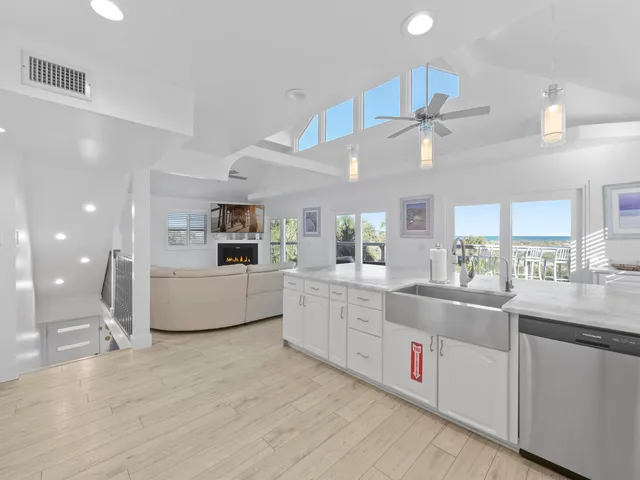 a kitchen with granite countertop kitchen island a sink stainless steel appliances and cabinets