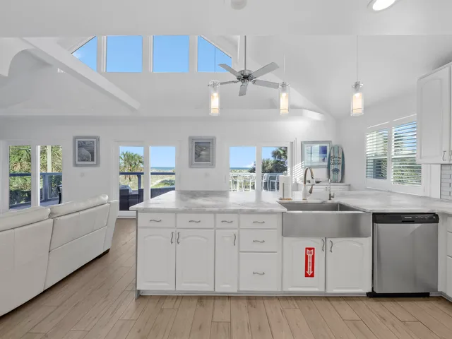 a kitchen with stainless steel appliances kitchen island granite countertop a table chairs and a refrigerator
