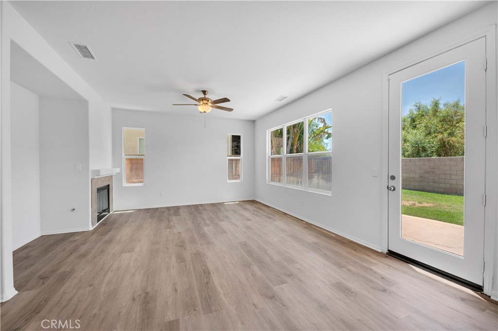 1984 Bronte Road San Jacinto, CA 92583 - Photo 11 of 30 a view of an empty room with wooden floor and a window
