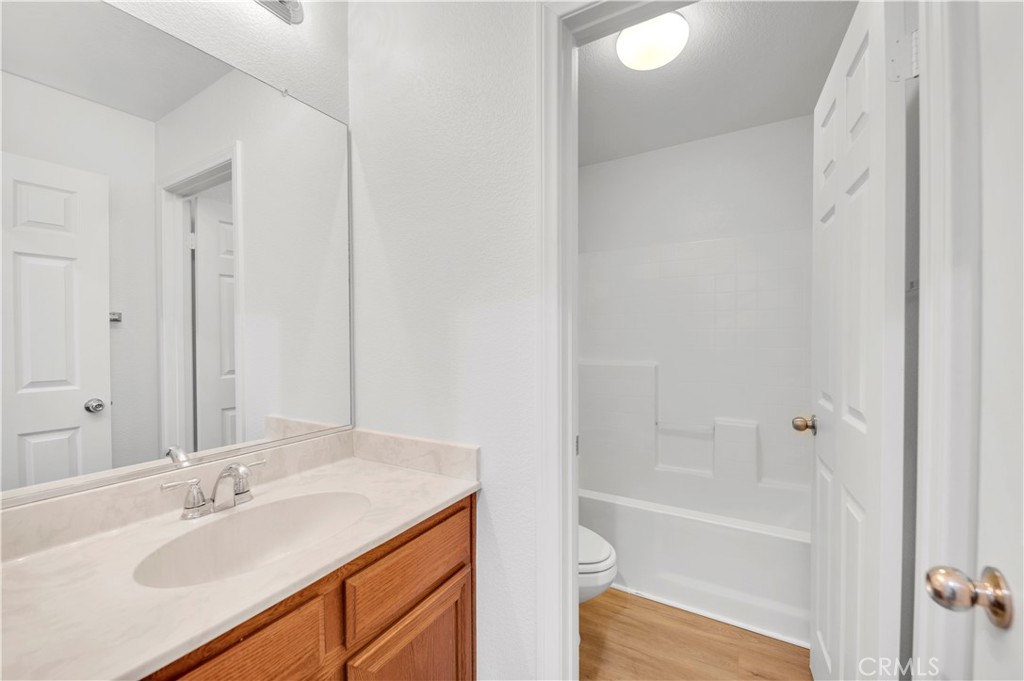 1984 Bronte Road San Jacinto, CA 92583 - Photo 12 of 30 a bathroom with a granite countertop sink toilet and shower