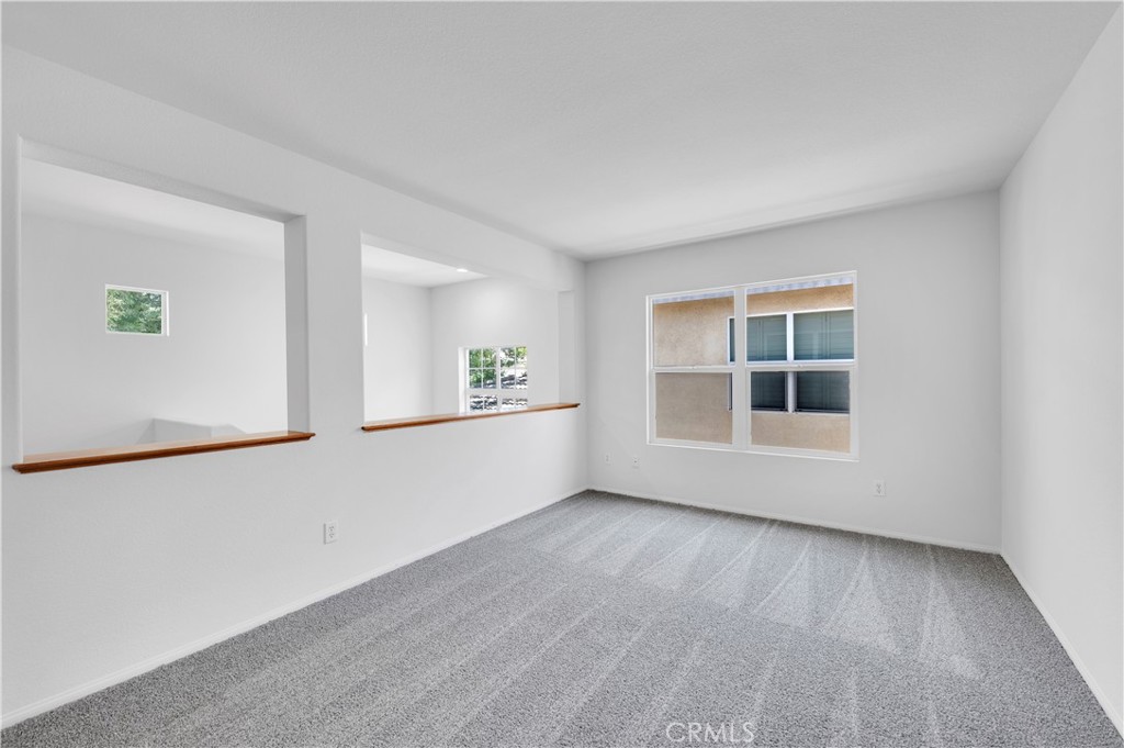 1984 Bronte Road San Jacinto, CA 92583 - Photo 16 of 30 an empty room with wooden floor and windows