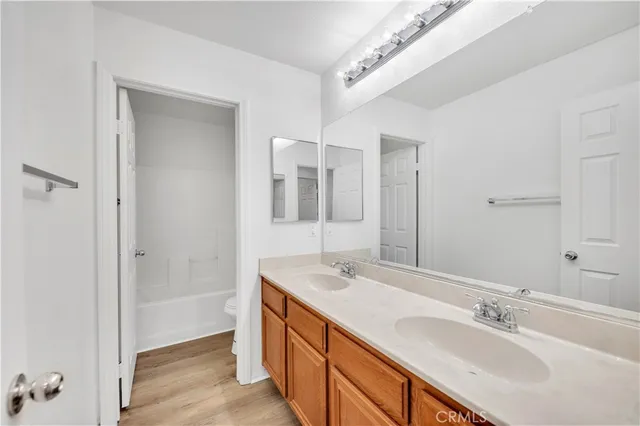 a bathroom with a sink double vanity and a mirror