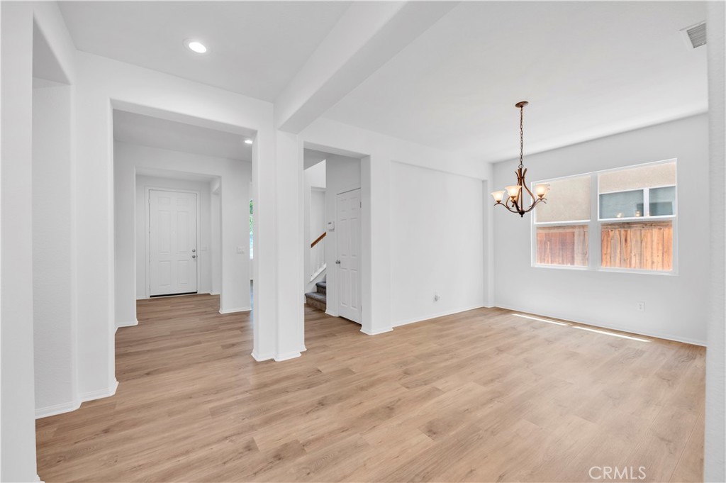 1984 Bronte Road San Jacinto, CA 92583 - Photo 7 of 30 a view of empty room with wooden floor and ceiling fan