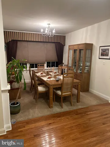 a view of a dining room with furniture large windows and wooden floor