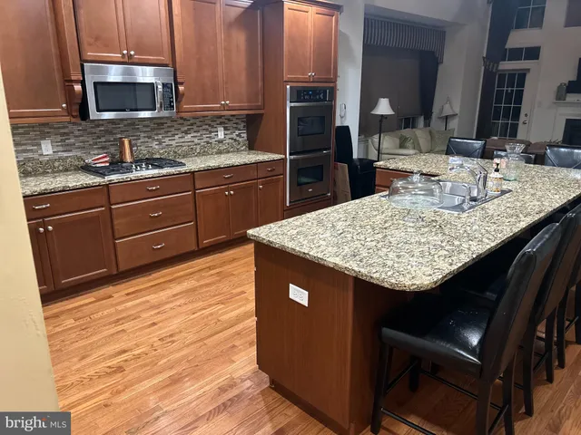 a kitchen with granite countertop a sink and a stove