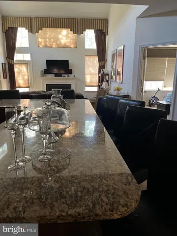 a kitchen with kitchen island granite countertop wooden cabinets and a refrigerator