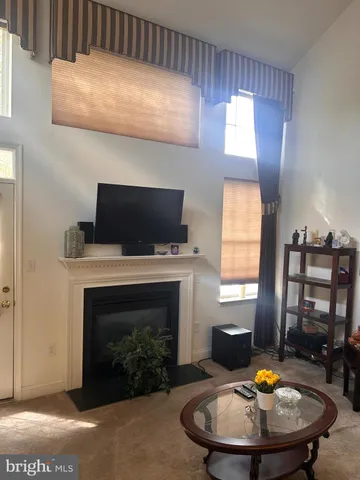 a living room with furniture large window and a table