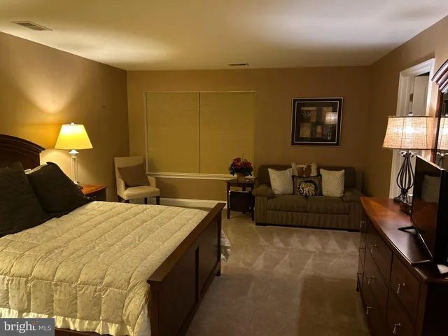 a bedroom with a bed and a night stand
