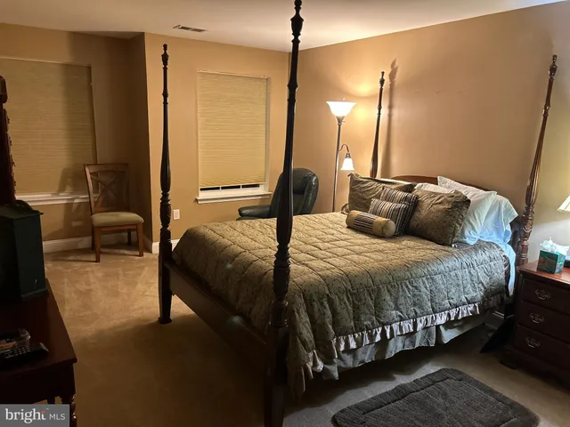 a bedroom with a bed closet and a mirror