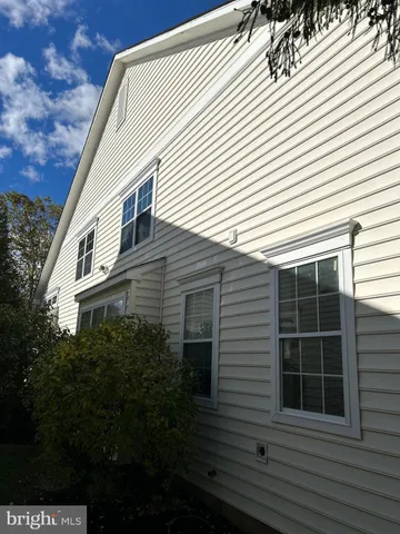 a view of backyard with plants and outdoor seating