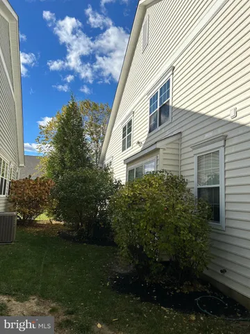 a view of a brick house with a small yard