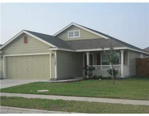 a front view of a house with a garden and yard