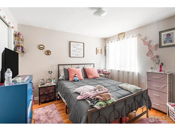 a bedroom with bed and a chandelier