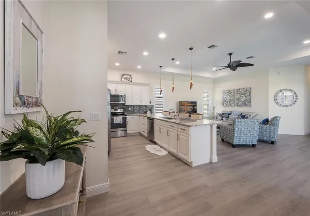 a kitchen with white cabinets and counter space