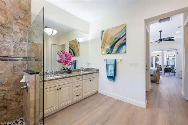 a kitchen with stainless steel appliances granite countertop a stove a sink and a wooden floor