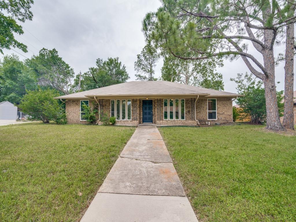 Ranch-style house with a front lawn and brick siding