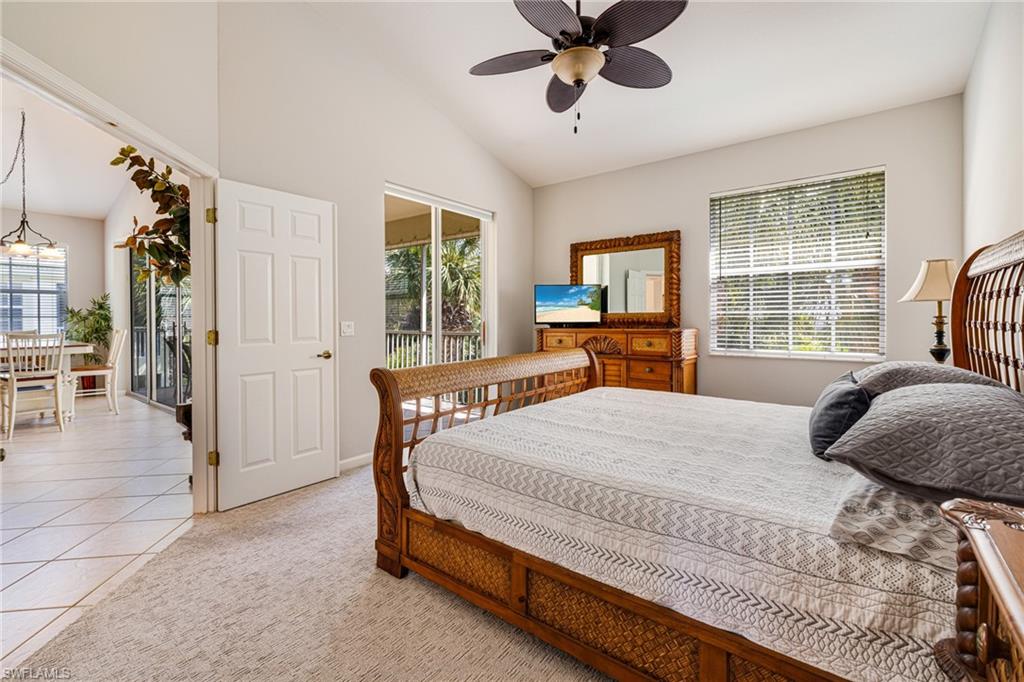 19081 Ridgepoint Drive, Unit 201 Estero, FL 33928 - Photo 14 of 50 a bedroom with a large bed and a chandelier