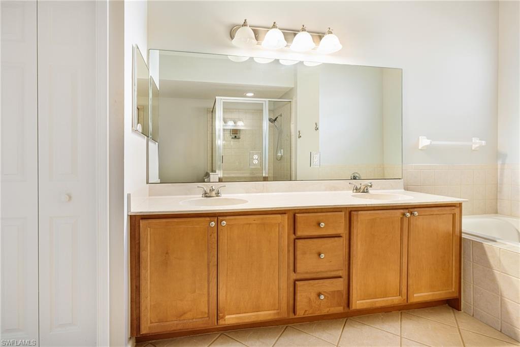 19081 Ridgepoint Drive, Unit 201 Estero, FL 33928 - Photo 16 of 50 a bathroom with a double vanity sink and a mirror