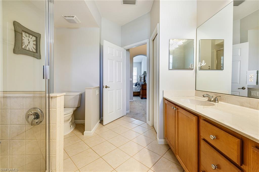 19081 Ridgepoint Drive, Unit 201 Estero, FL 33928 - Photo 17 of 50 a bathroom with a double vanity sink a toilet and shower