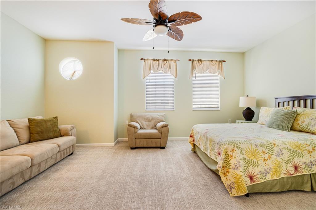 19081 Ridgepoint Drive, Unit 201 Estero, FL 33928 - Photo 20 of 50 a spacious bedroom with a bed and window