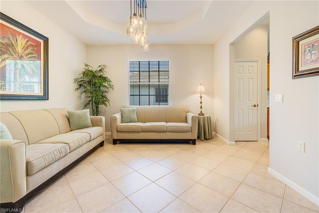 19081 Ridgepoint Drive, Unit 201 Estero, FL 33928 - Photo 2 of 50 a living room with furniture and a chandelier