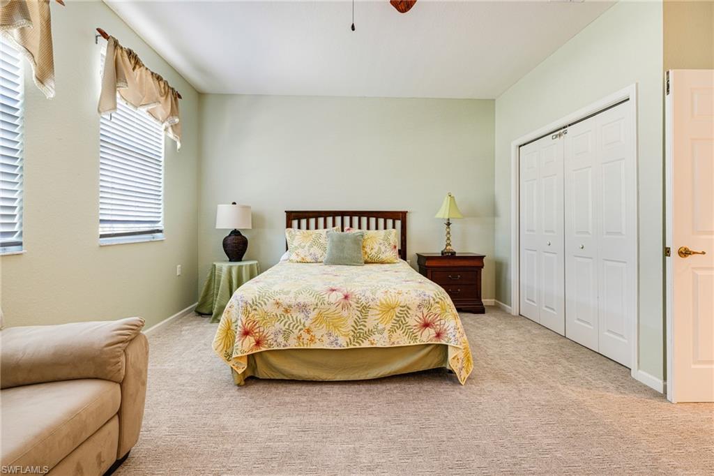 19081 Ridgepoint Drive, Unit 201 Estero, FL 33928 - Photo 21 of 50 a bedroom with a bed and a window