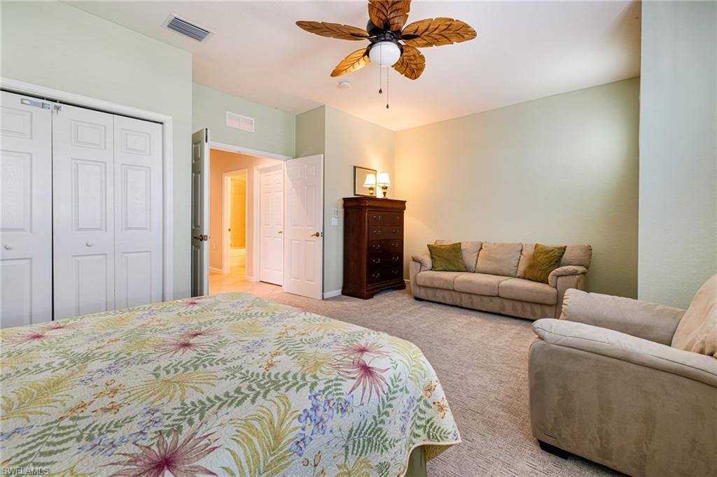 19081 Ridgepoint Drive, Unit 201 Estero, FL 33928 - Photo 23 of 50 a spacious bedroom with a bed and couch