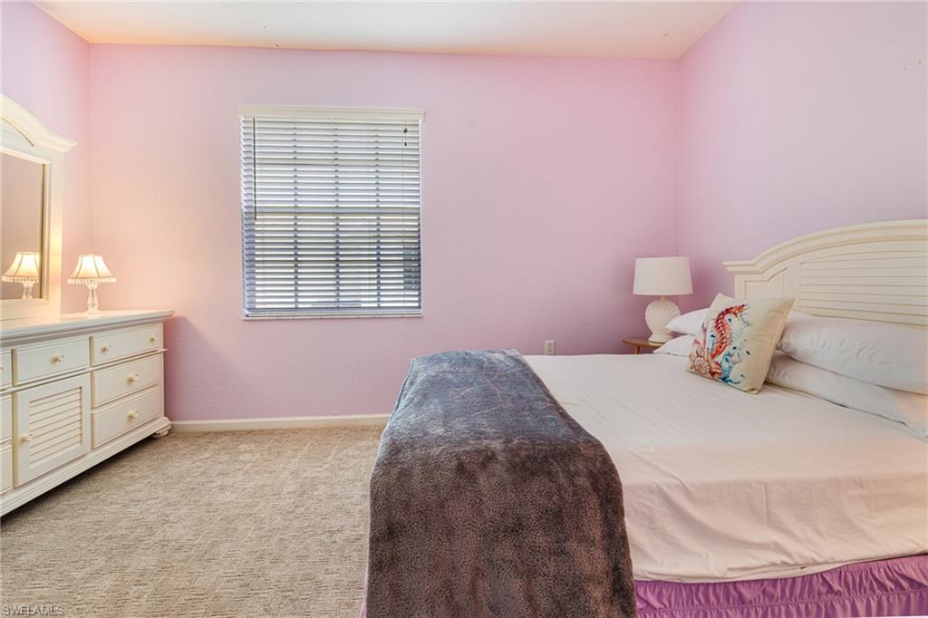 19081 Ridgepoint Drive, Unit 201 Estero, FL 33928 - Photo 27 of 50 a bedroom with a bed and a window