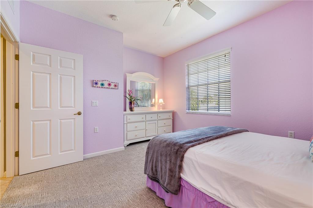 19081 Ridgepoint Drive, Unit 201 Estero, FL 33928 - Photo 28 of 50 a bedroom with a bed and a closet