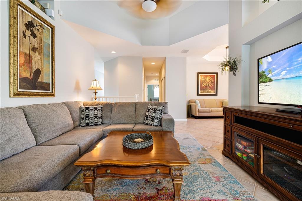 19081 Ridgepoint Drive, Unit 201 Estero, FL 33928 - Photo 5 of 50 a living room with furniture and a flat screen tv