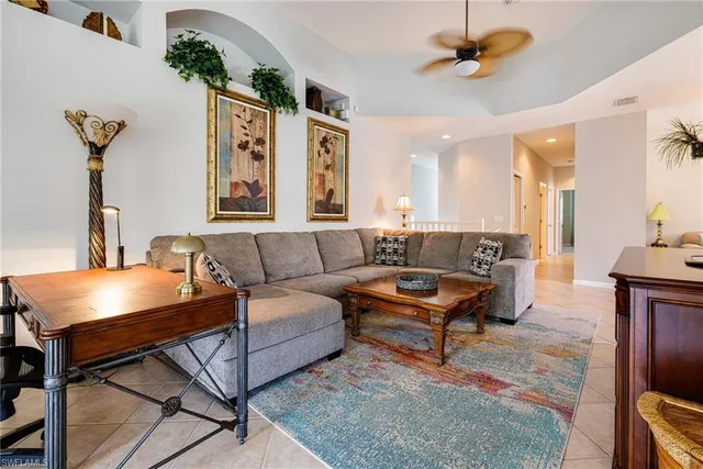 a living room with furniture and a potted plant