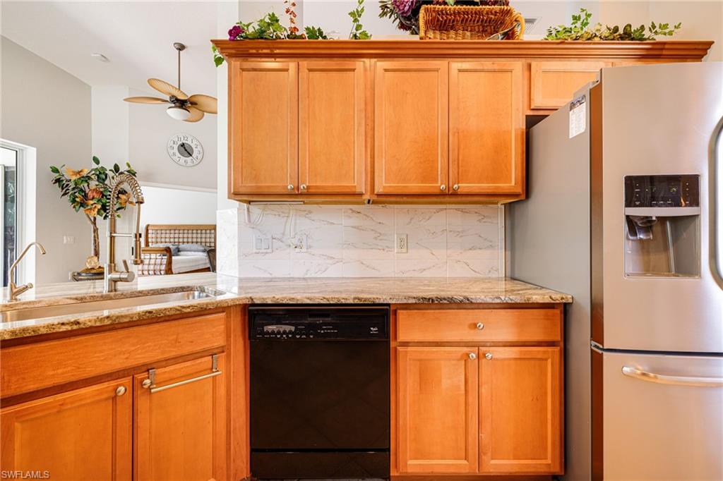 19081 Ridgepoint Drive, Unit 201 Estero, FL 33928 - Photo 9 of 50 a kitchen with stainless steel appliances granite countertop a refrigerator and a sink