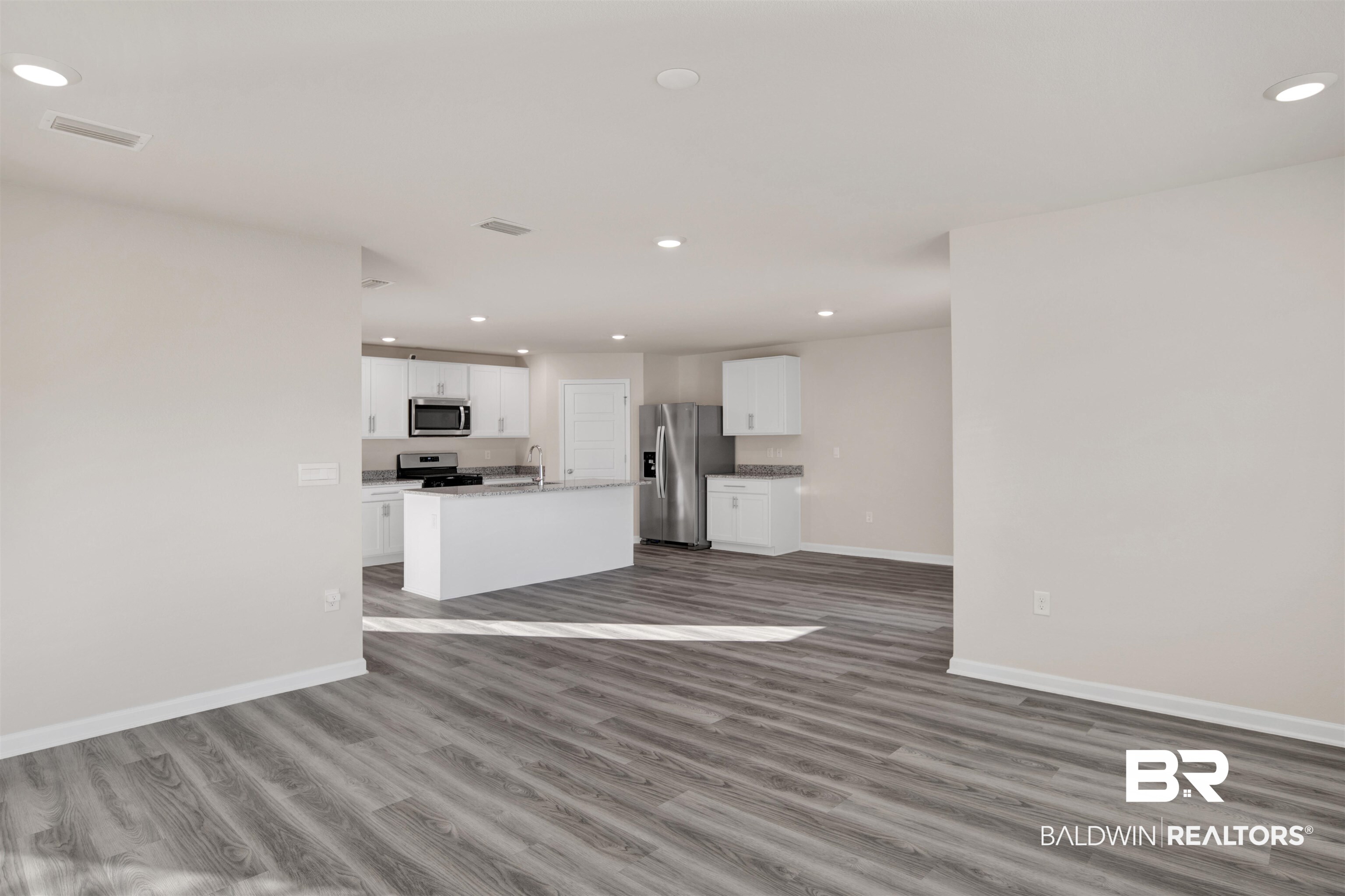 32038 Lyon Road Daphne, AL 36527 - Photo 22 of 30 Unfurnished living room with recessed lighting and dark wood-style flooring