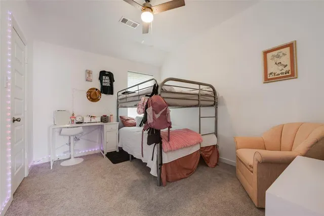 a bedroom with bed and a chandelier