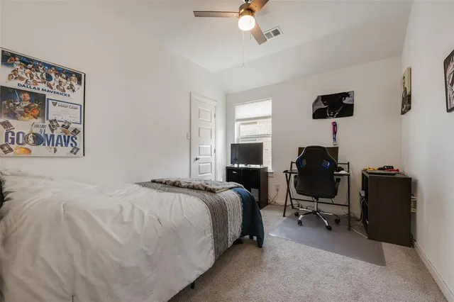 a bedroom with a bed and a desk