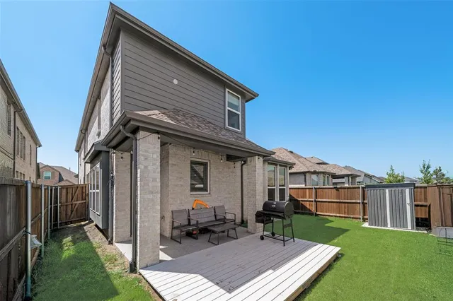 a backyard of a house with table and chairs